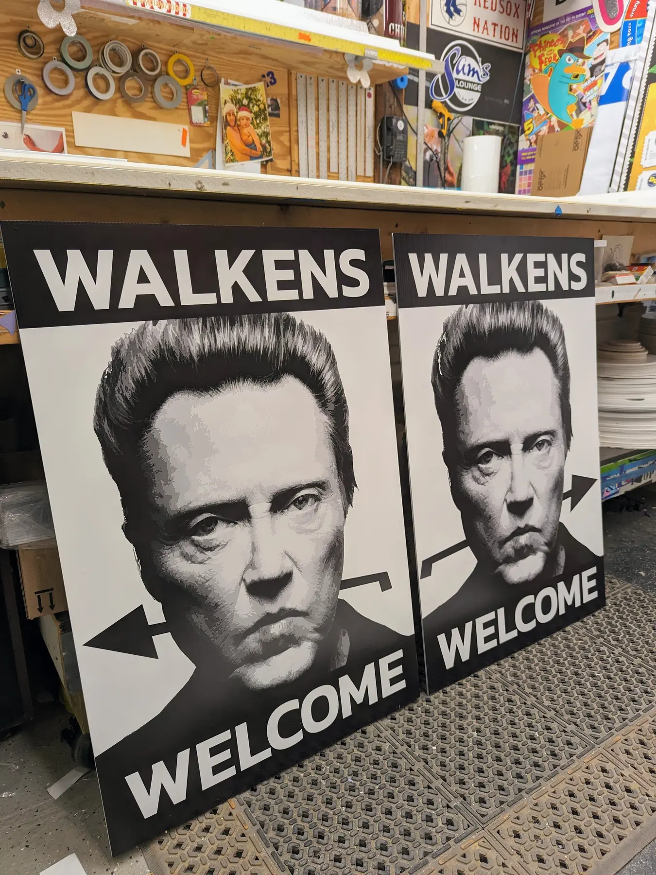 Two black and white Walkens Welcome printed sandwich board sign inserts